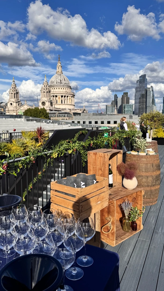 Rooftop wine tasting set-up with St Paul's Cathedral and London's skyline behind it