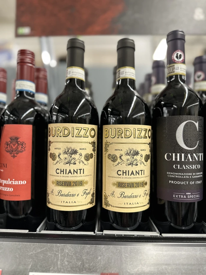 Chianti bottles, including Burdizzo Chianti Riserva 2019, displayed on a wine shelf