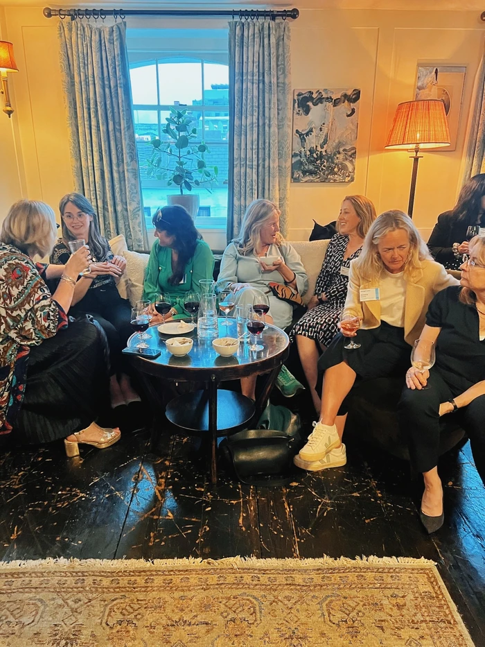 Women enjoying a wine tasting around a table in a stylish lounge