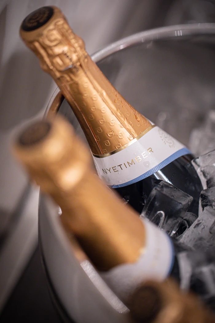 Nyetimber sparkling wine bottle resting in an ice bucket