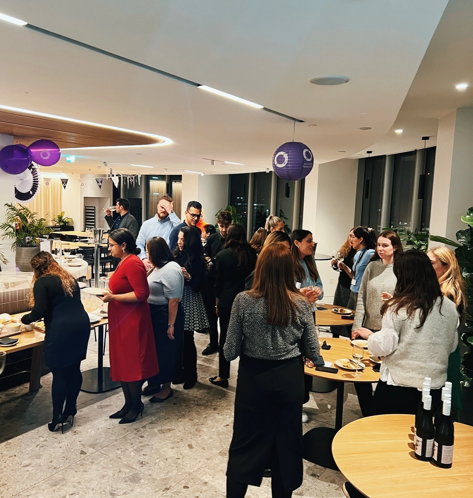 Guests mingle with wine and canapés at a decorated professional wine tasting