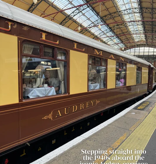 The British Pullman’s Audrey carriage at a covered railway platform