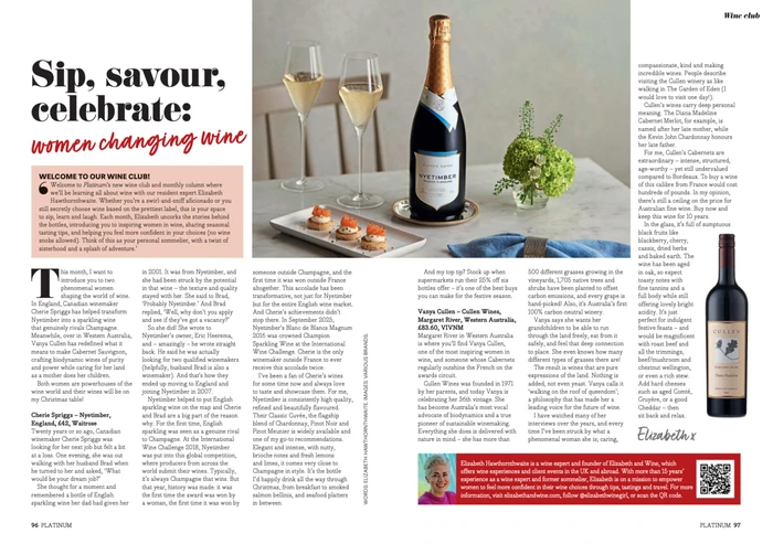 Champagne bottle, two glasses, canapés and small floral arrangement on table