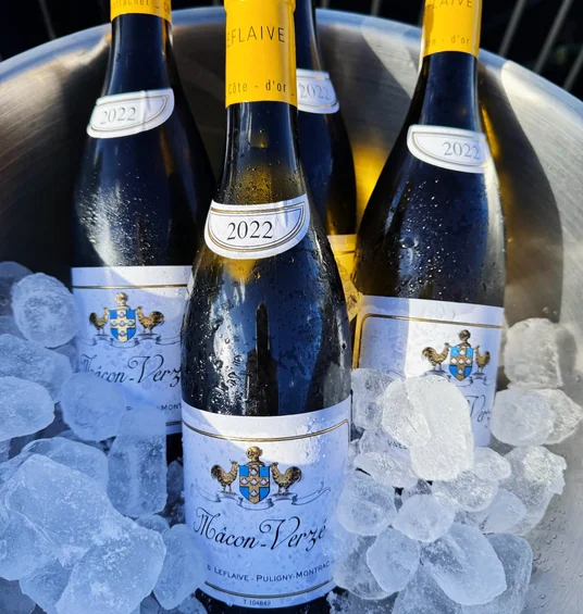 Four bottles of Mâcon-Verzé wine chilling in ice