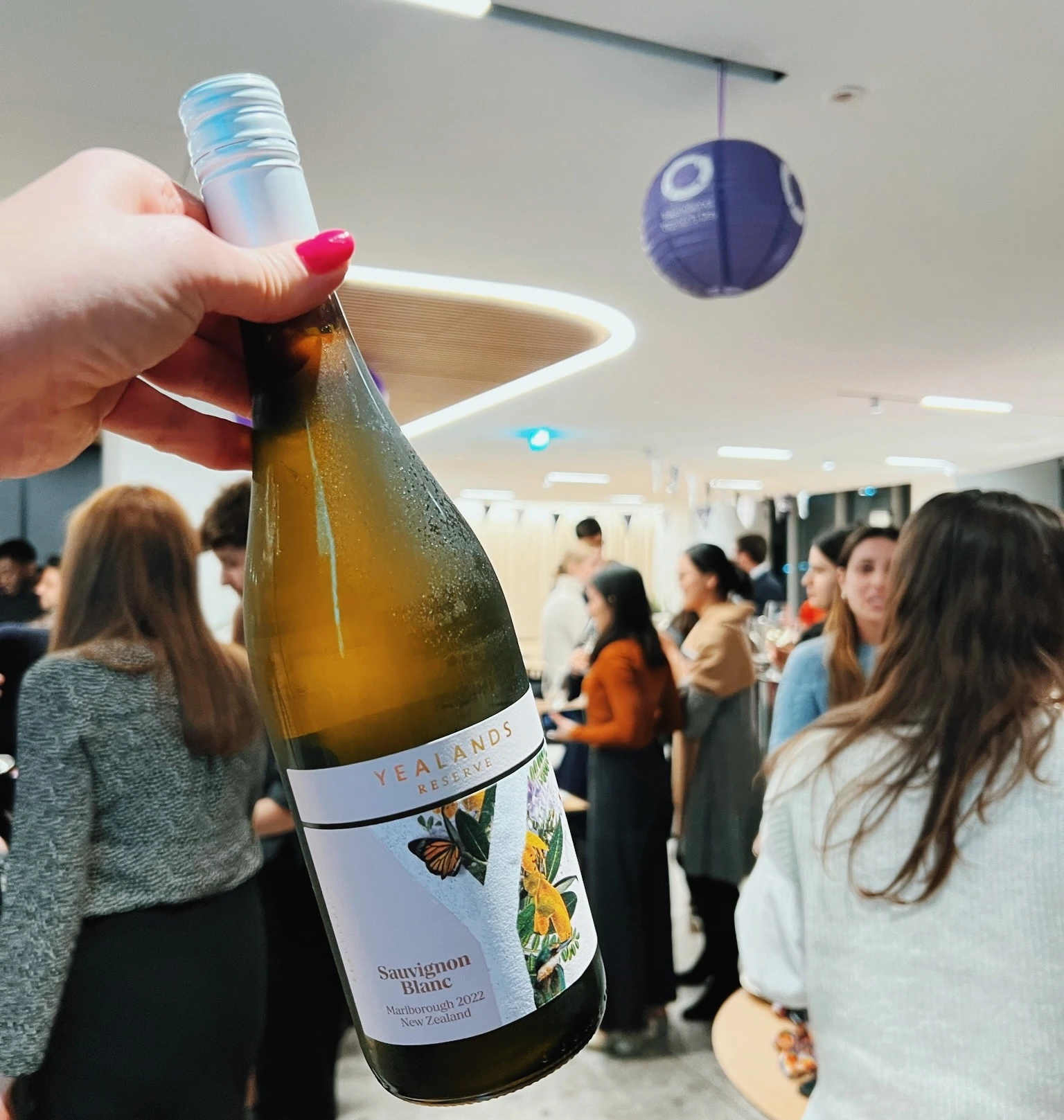 Bottle of Yealands Reserve Sauvignon Blanc held up at a corporate wine tasting