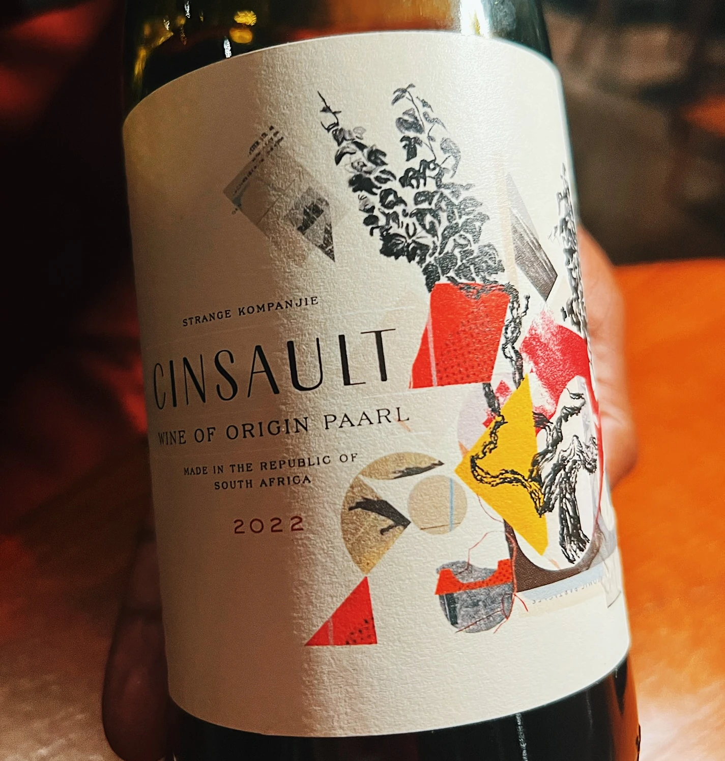 Close-up of a Cinsault wine bottle with a colourful illustrated label