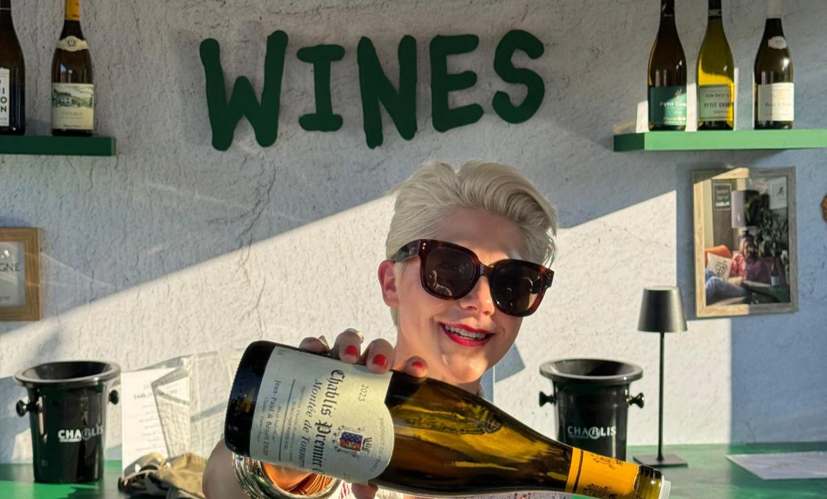 Woman pouring white wine at Chablis Wines stall