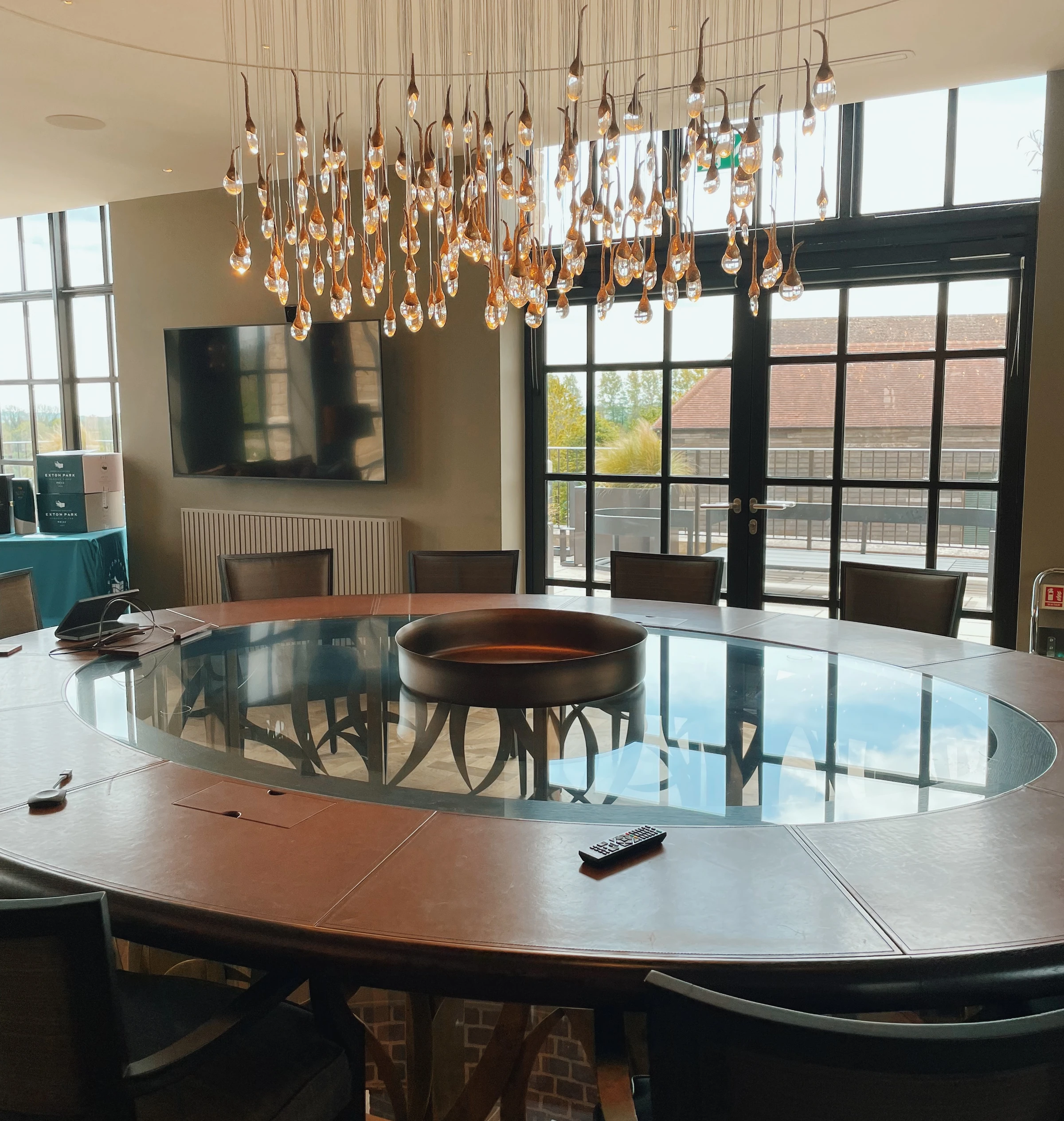 Exton Park tasting room with a large round table and a chandelier of hanging glass droplets
