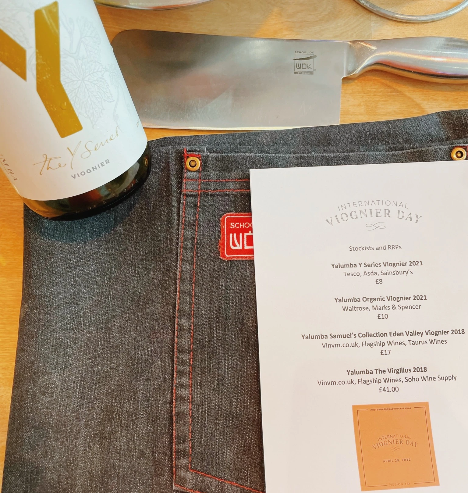 The Secret Viognier bottle beside an International Viognier Day tasting sheet and kitchen knife