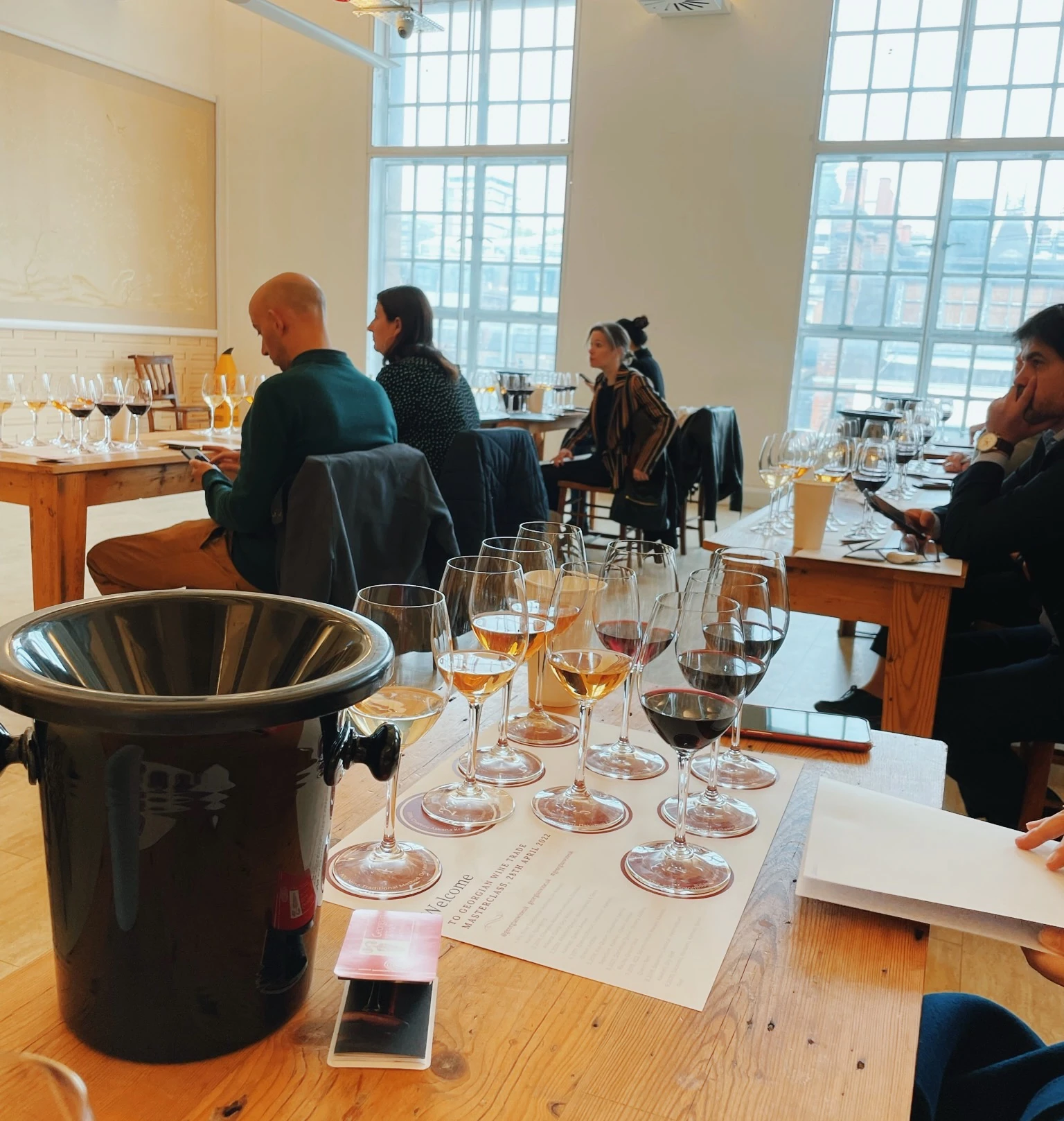 Georgia wine tasting with guests seated among wine glasses in a bright event space