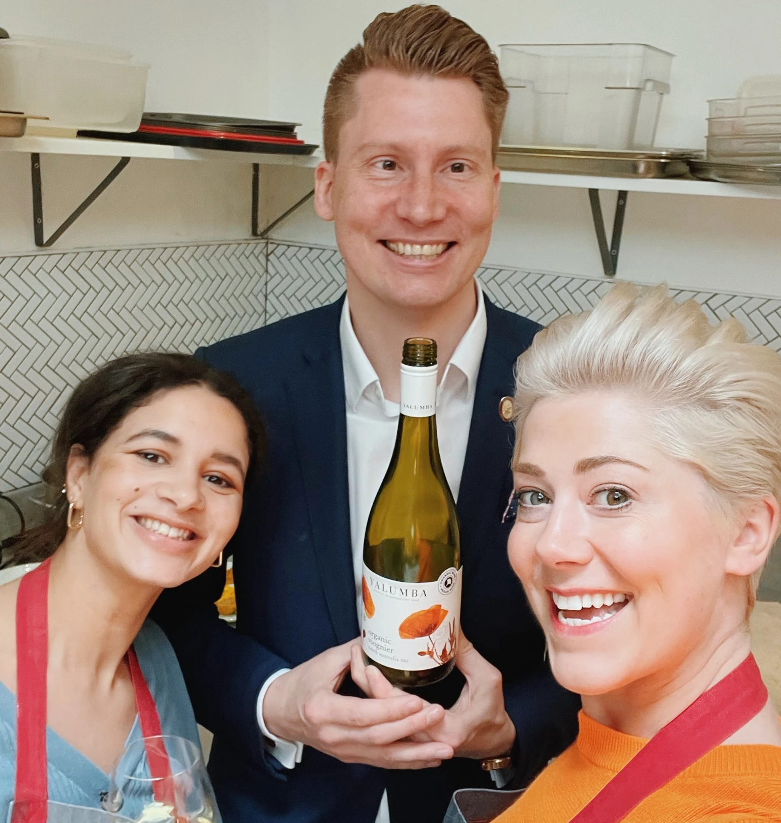 Three people pose with a bottle of Yalumba Organic Viognier and a glass of white wine