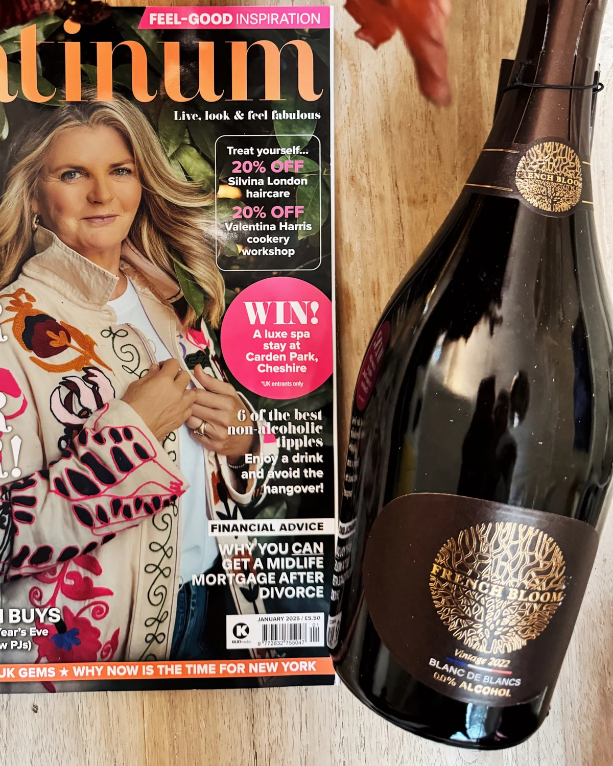 Magazine featuring a woman beside a French Bloom Blanc de Blancs bottle