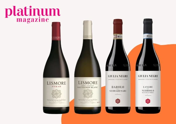 Platinum magazine graphic featuring four wine bottles against an orange background