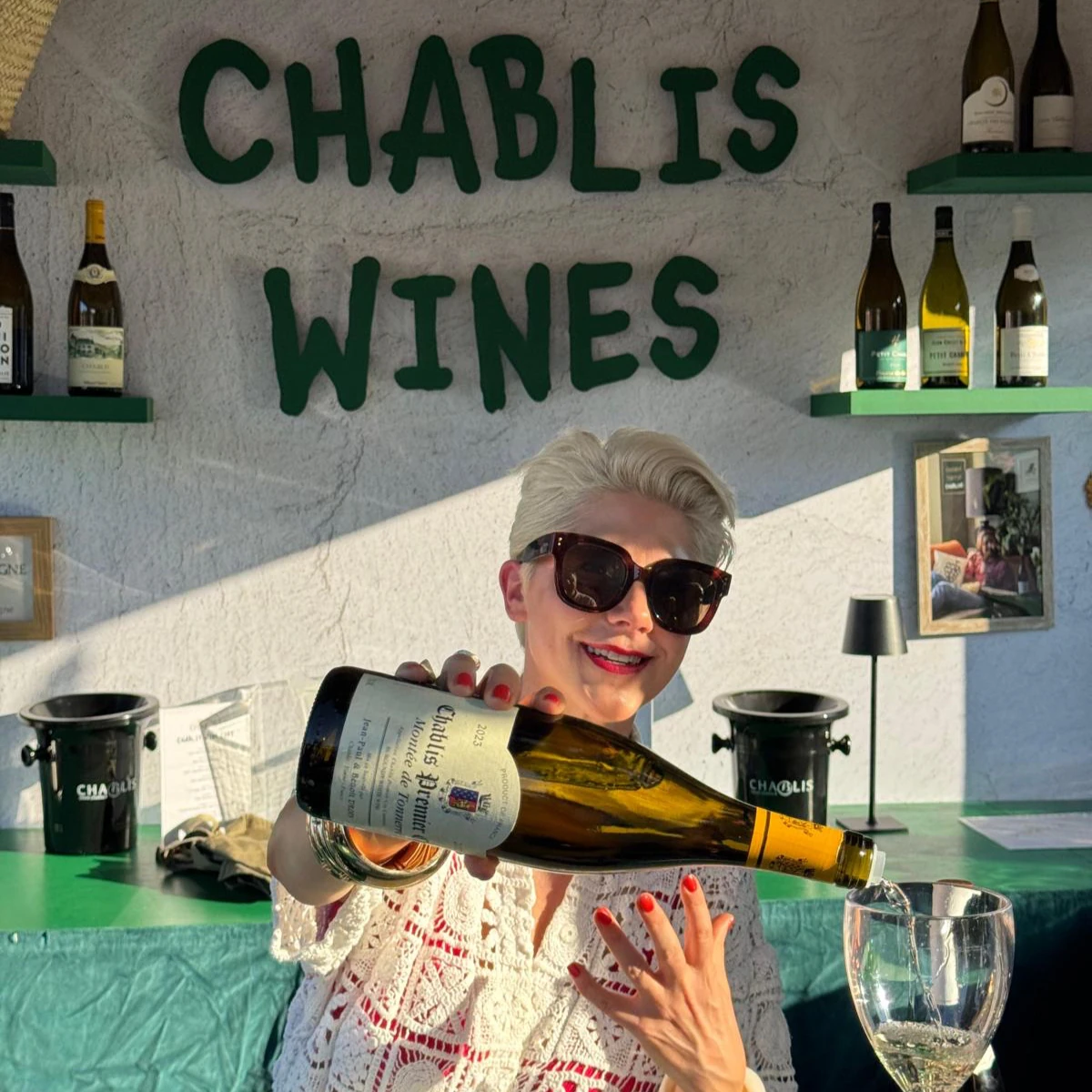 Woman pouring white wine at Chablis Wines stall