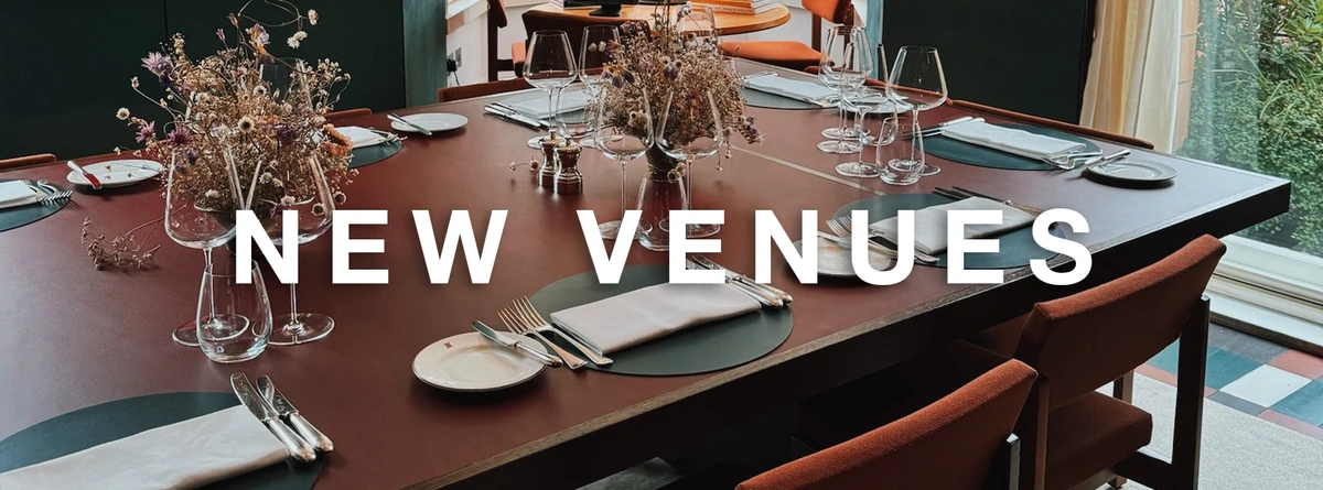 NEW VENUES over a set dining table in a restaurant