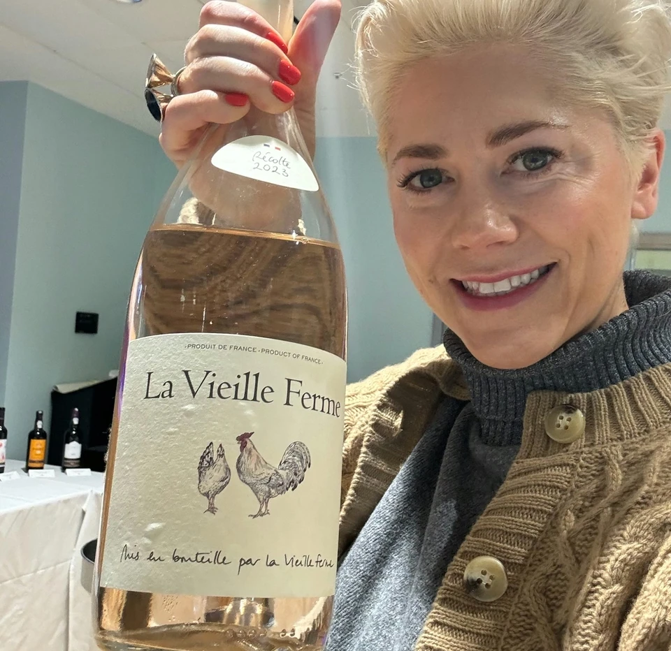 Person holding a bottle of La Vieille Ferme rosé at an indoor Sainsbury’s wine event