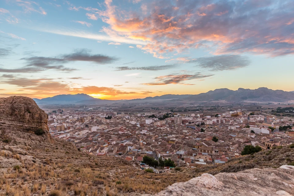 Sunset over Jumilla, a Spanish town and valley viewed from a rocky hillside