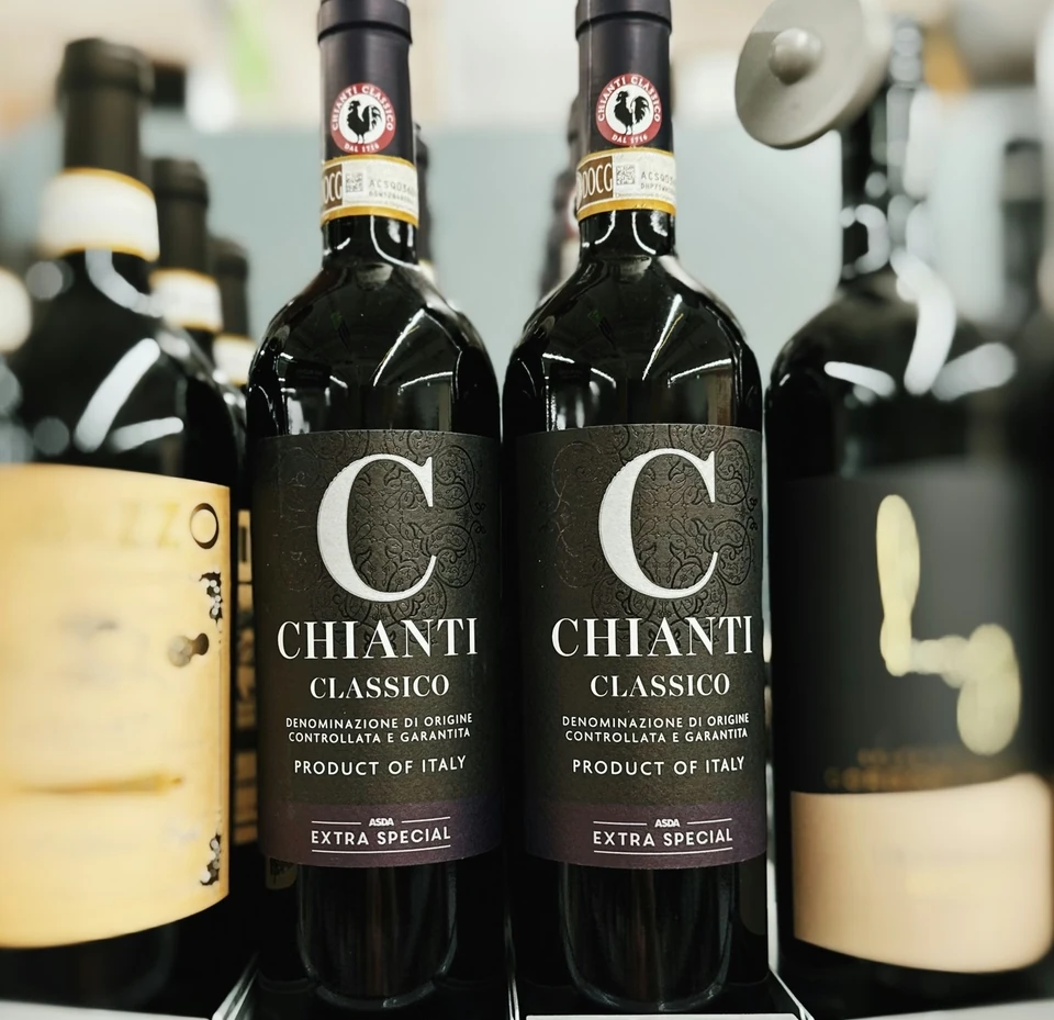 Two Chianti Classico Extra Special wine bottles displayed among other bottles