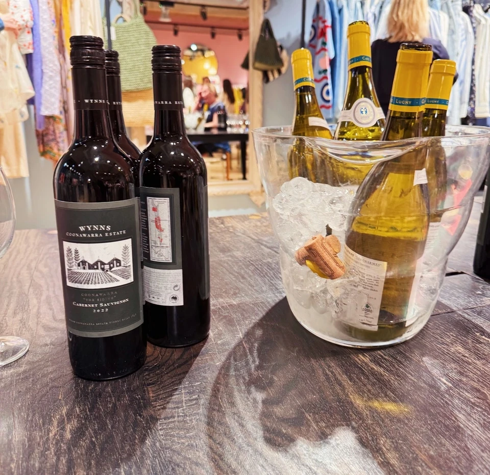 Wynns Coonawarra Estate Cabernet Sauvignon 2022 and other wine bottles on a wooden table