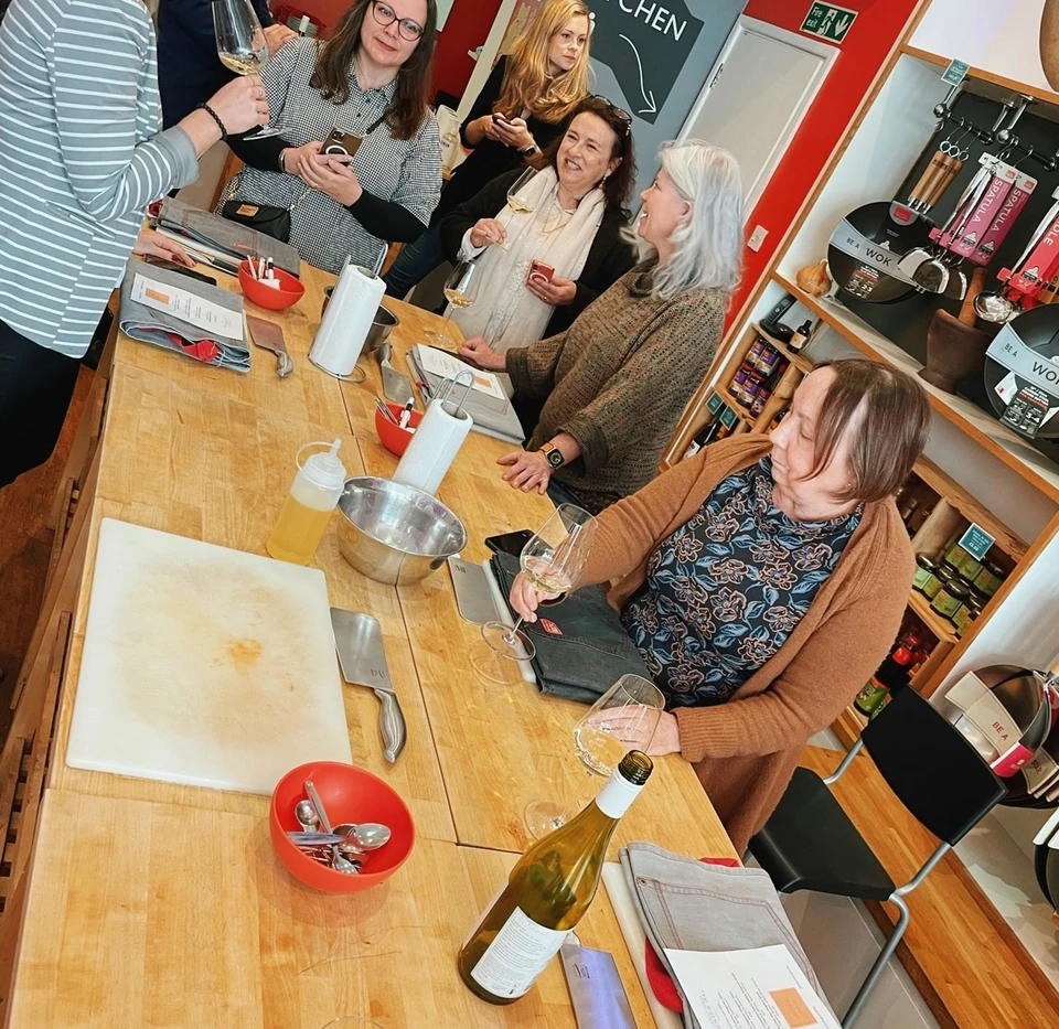 Guests tasting Viognier around a kitchen island