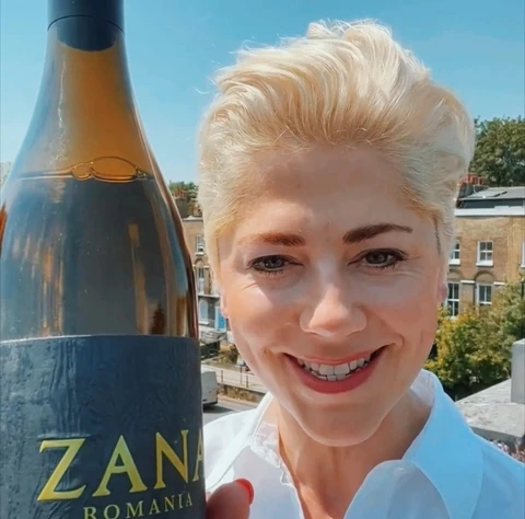 A Zana Sauvignon Blanc bottle held outdoors