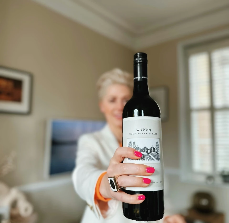 Hand holding a bottle of Wynns Coonawarra Estate Cabernet Sauvignon wine