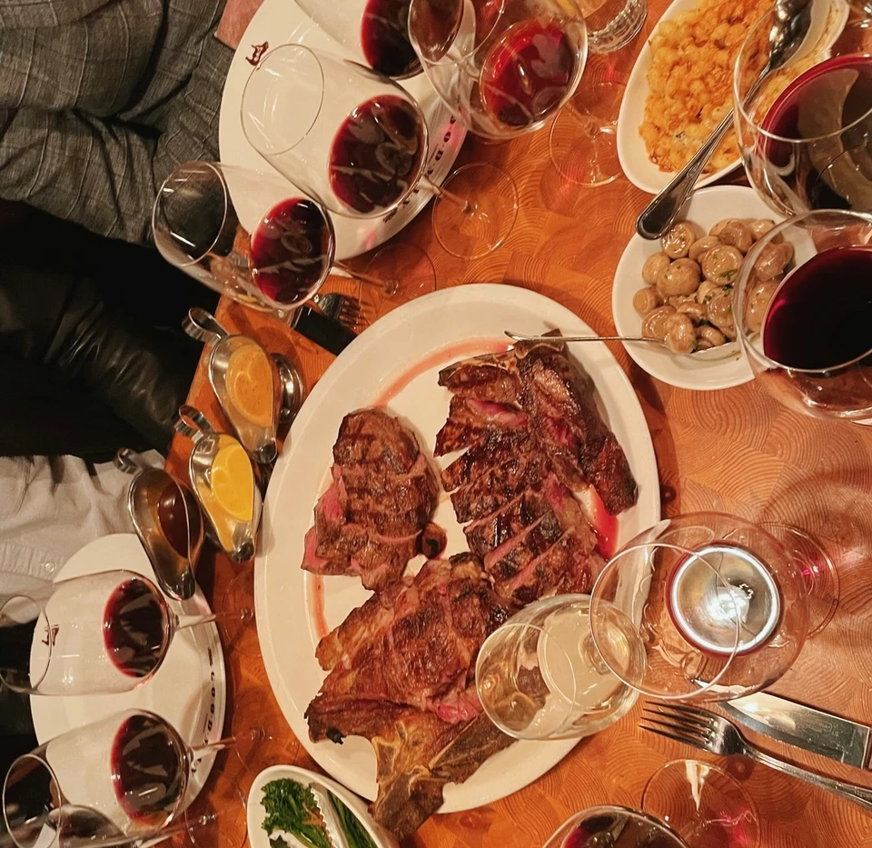 Argentinian red wine served with steak and side dishes at a tasting table
