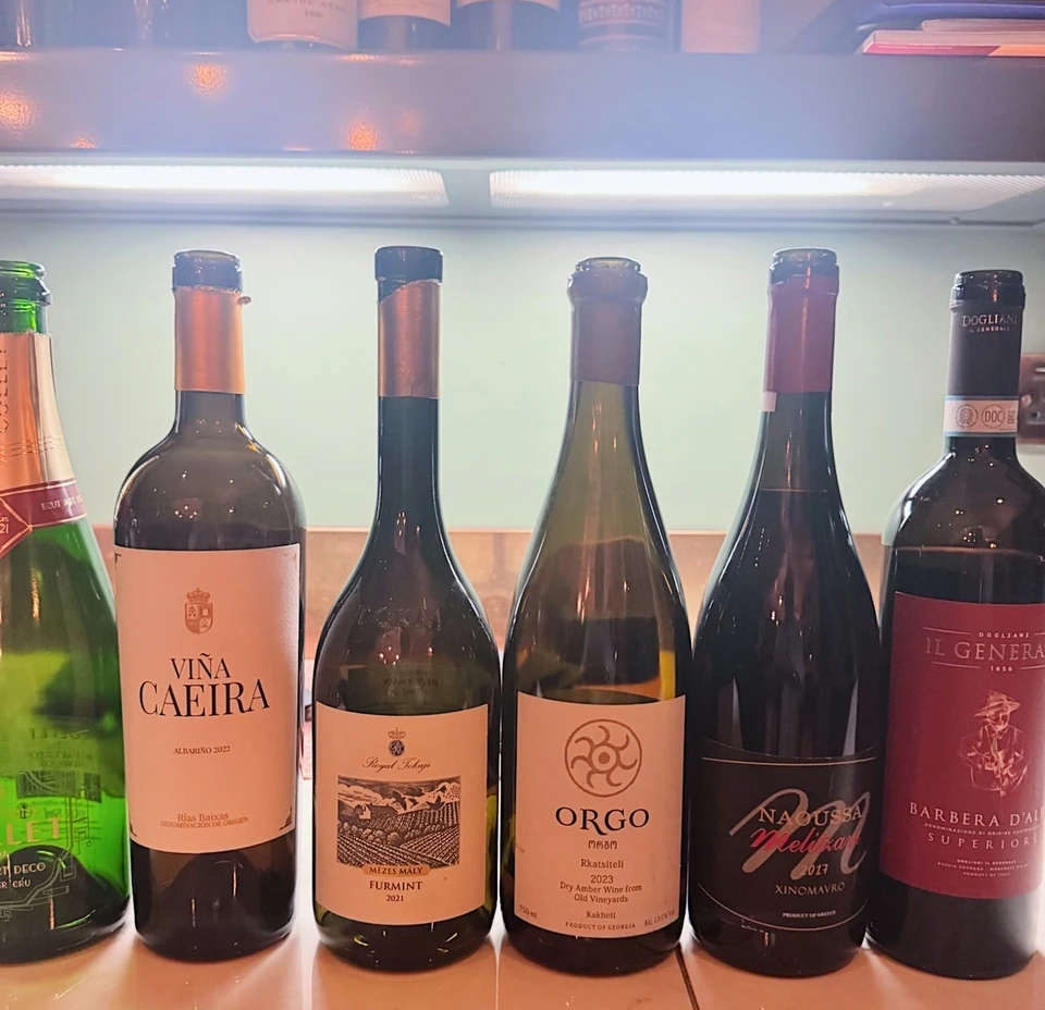 Wine bottles displayed on a tiled counter, including a bottle labelled Barbera