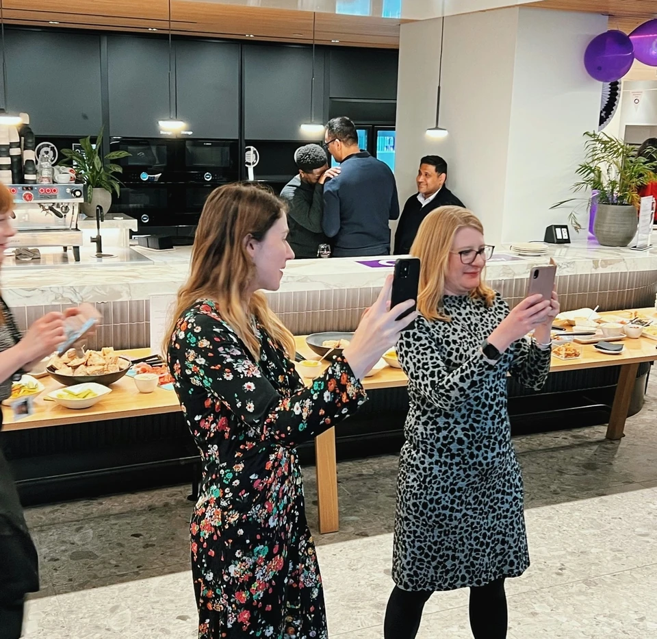 Guests use their phones at a corporate wine event for Simpson Thacher & Bartlett