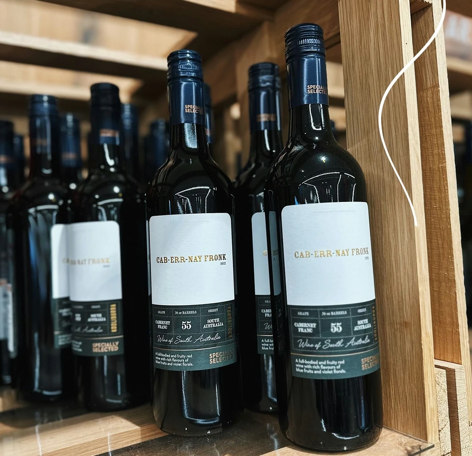 Bottles of Australian red wine arranged on wooden shelves