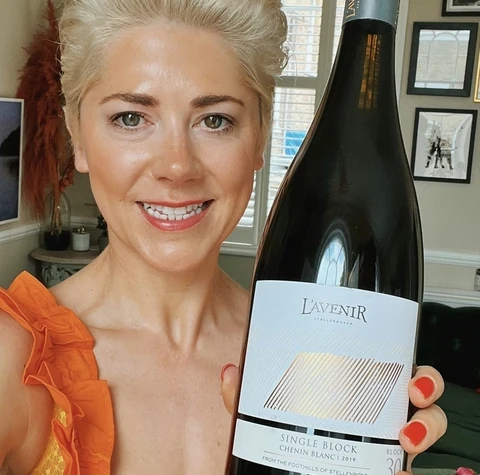 L'Avenir Chenin Blanc bottle held by a smiling woman