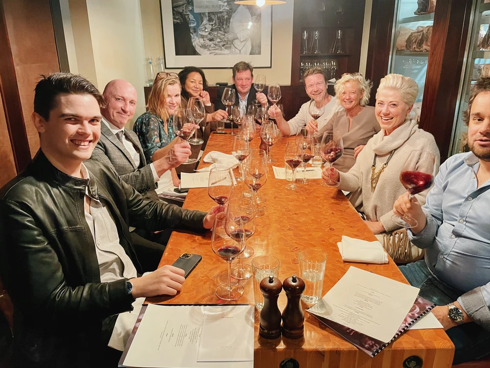 Guests raising wine glasses at a restaurant table during an Argentinian wine tasting