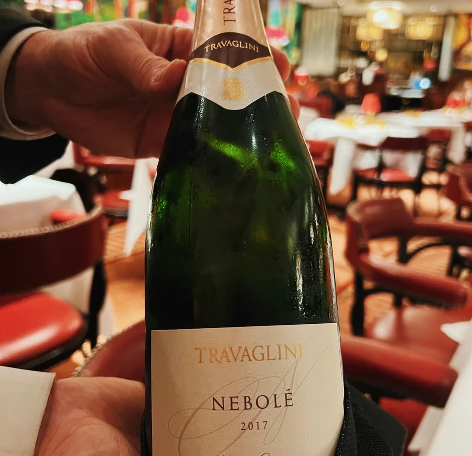 Travaglini Nebolè 2017 sparkling wine bottle held inside The Colony Grill Room