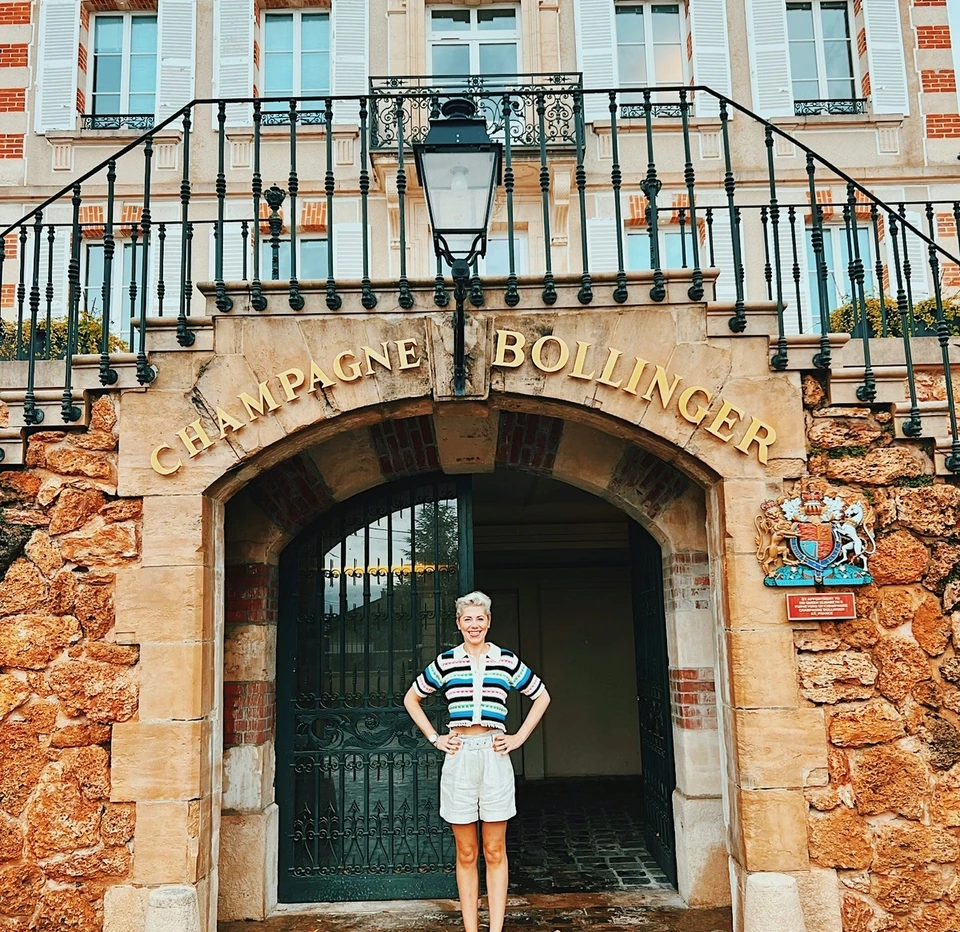 Person standing outside the Champagne Bollinger entrance in Épernay