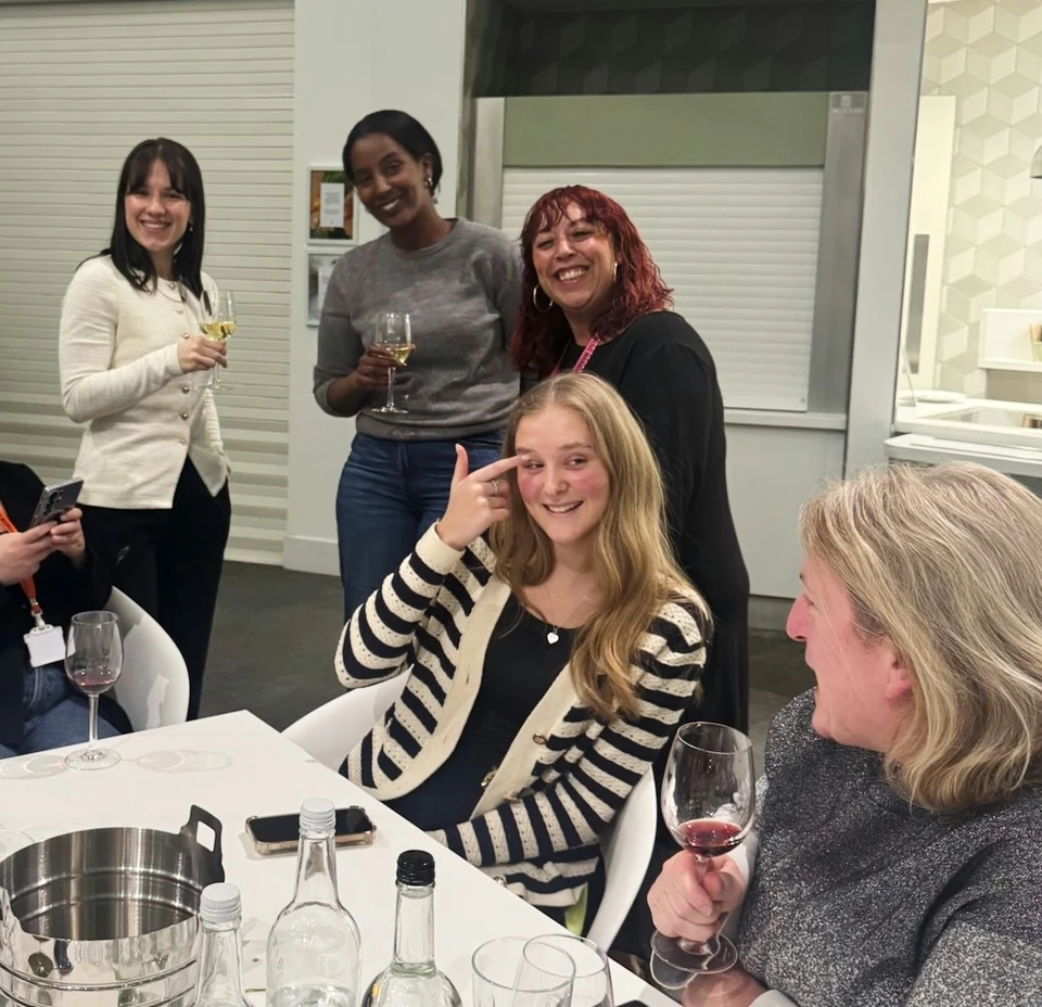 Guests enjoying wine at a tasting table