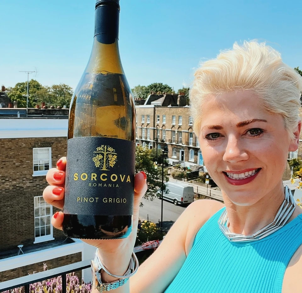 Bottle of Sorcova Pinot Grigio held on a sunny balcony