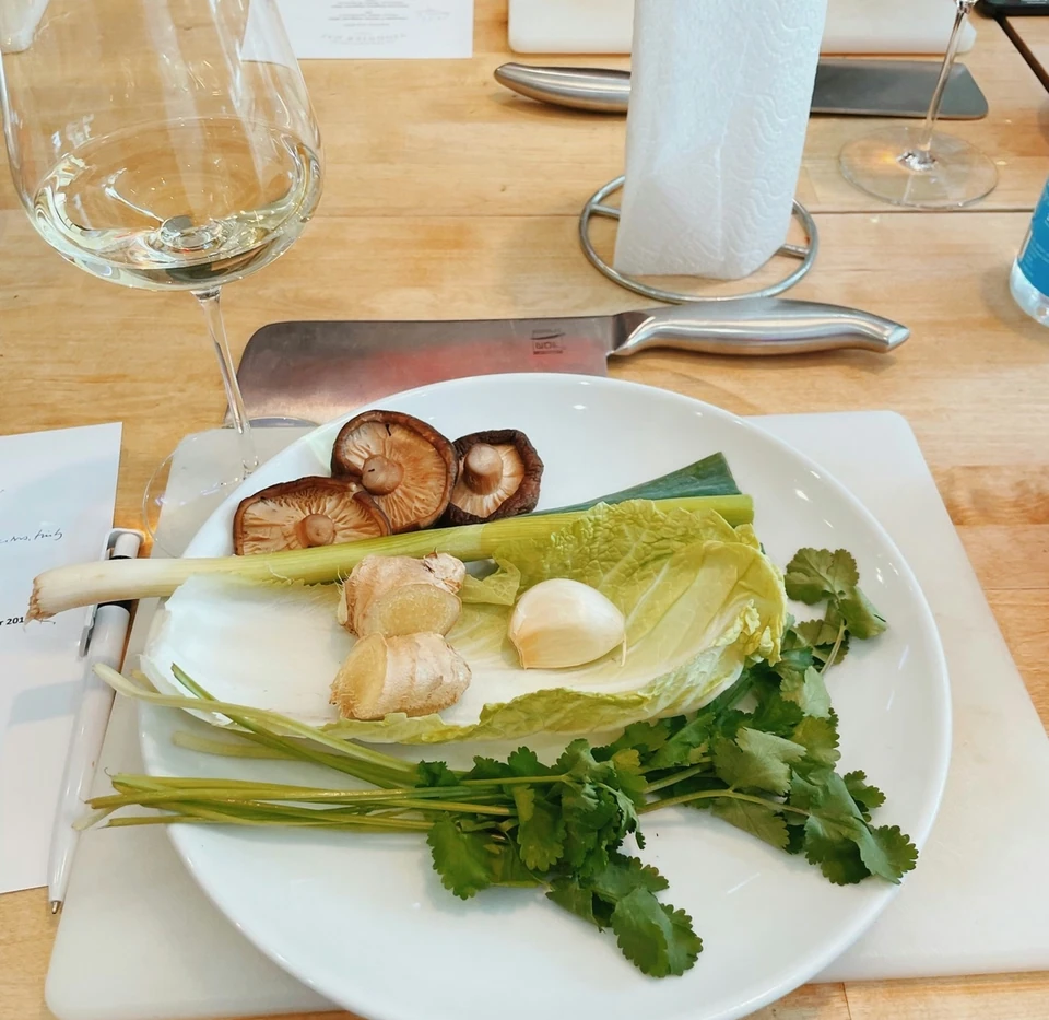 Wine glasses and fresh ingredients arranged on a table for a Viognier tasting