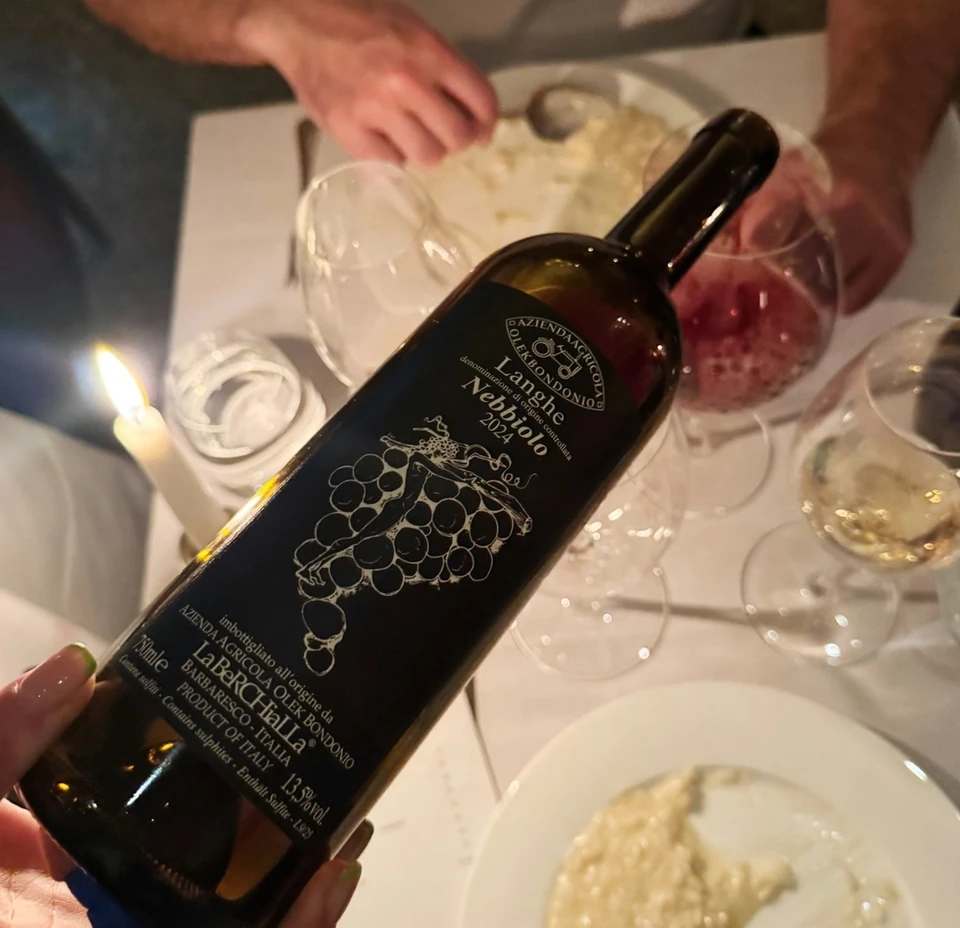 Bottle of LaBelle Calla Langhe Nebbiolo over a candlelit dinner table