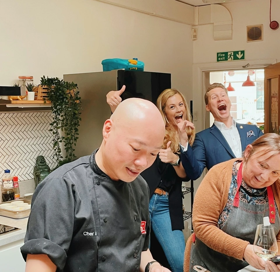 Chef and guests laughing during a Viognier wine tasting