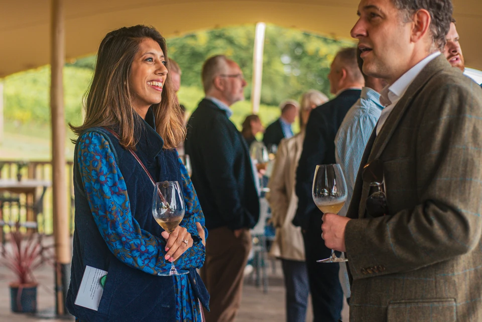 Guests chat over wine at a networking event