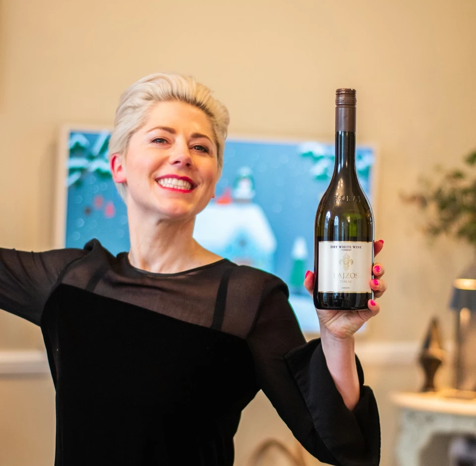 Elizabeth holding a bottle of Furmint wine