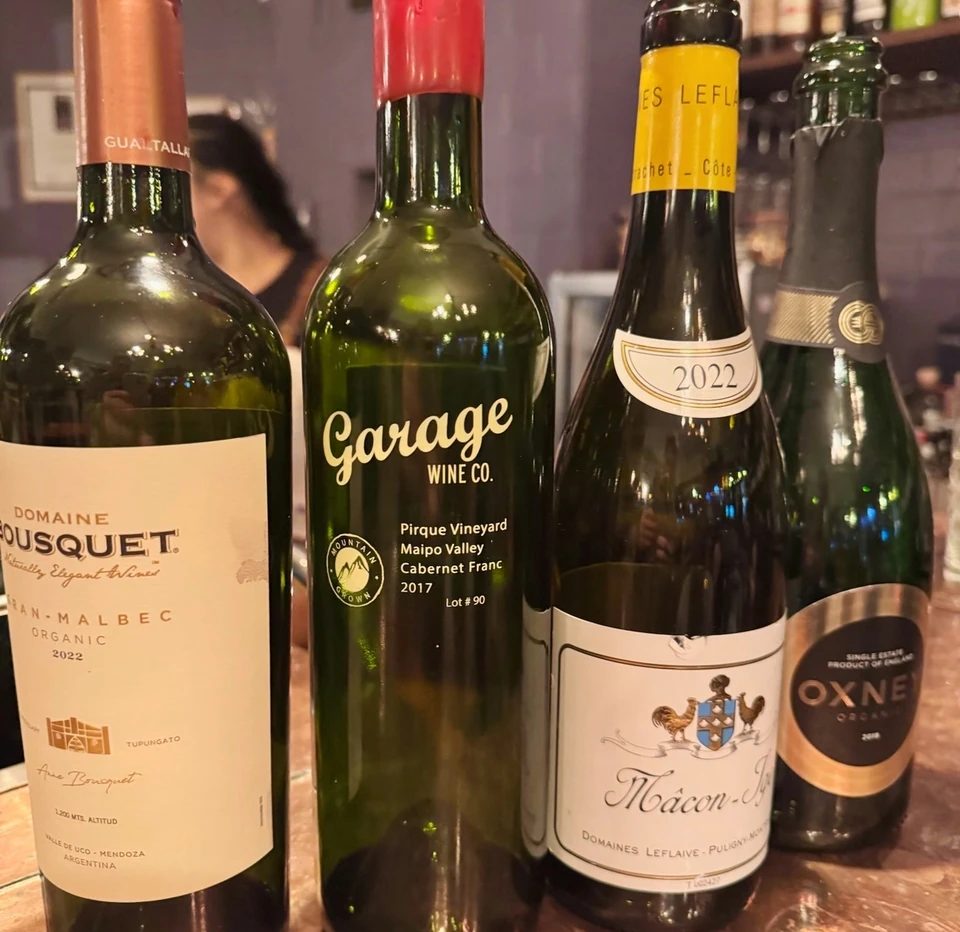 Garage Wine Co. Cabernet Franc and other wine bottles displayed on a wooden bar