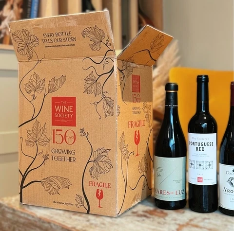 Wine Society 150th anniversary box beside three wine bottles