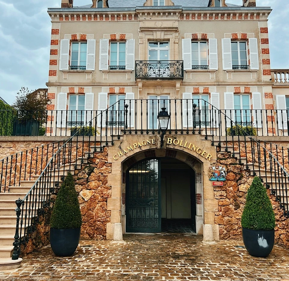 Bollinger Champagne house with stone entrance, formal steps and the name Bollinger above the doorway