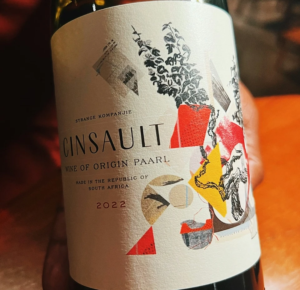 Close-up of a Cinsault wine bottle with a colourful illustrated label
