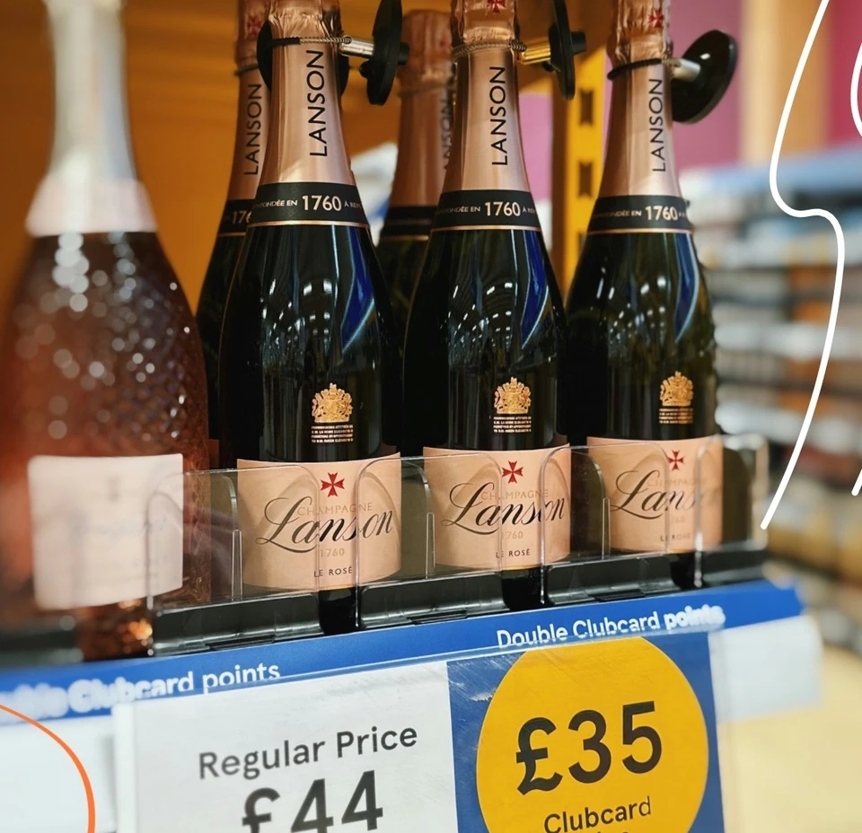 Lanson Le Rosé Champagne bottles on a Tesco shelf with Clubcard pricing