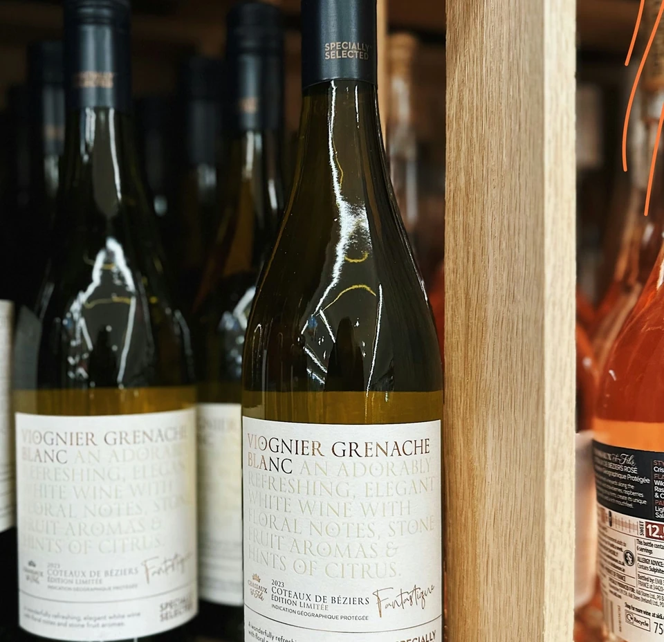 Bottle of Viognier Grenache Blanc wine displayed on a wooden shelf