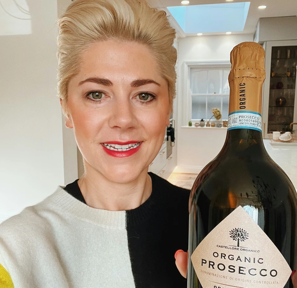 Castellore Organic Prosecco bottle held up in a bright kitchen