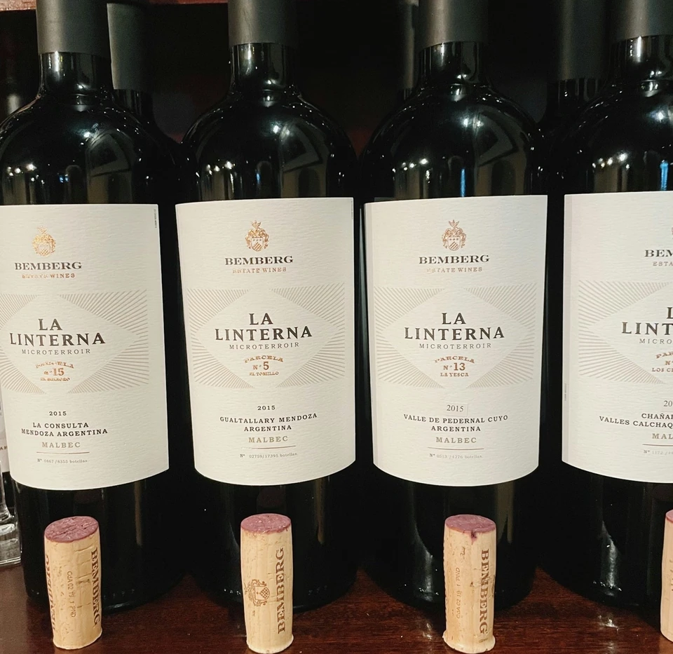 Bemberg La Linterna Malbec wine bottles arranged on a wooden shelf