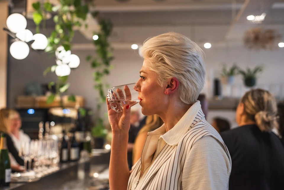 Guest tasting wine at an Elizabeth & Wine event at Stem + Stem